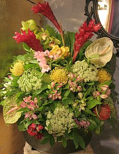 Mother's day bouquet made of red alpinia on top, green and yellow cymbidium orchid, etc.